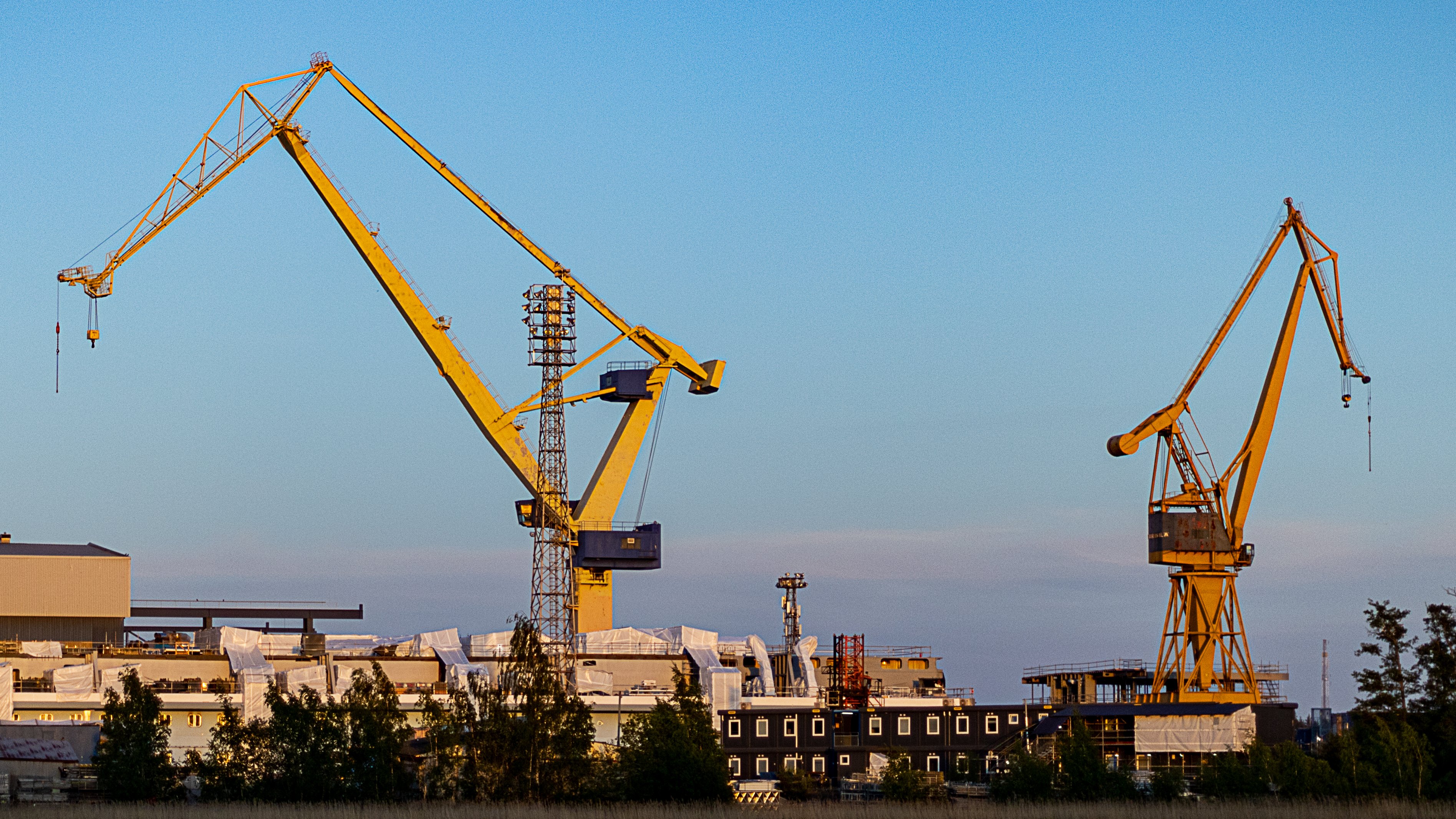 Kaksi isoa keltaista nosturia rakennustyömaalla