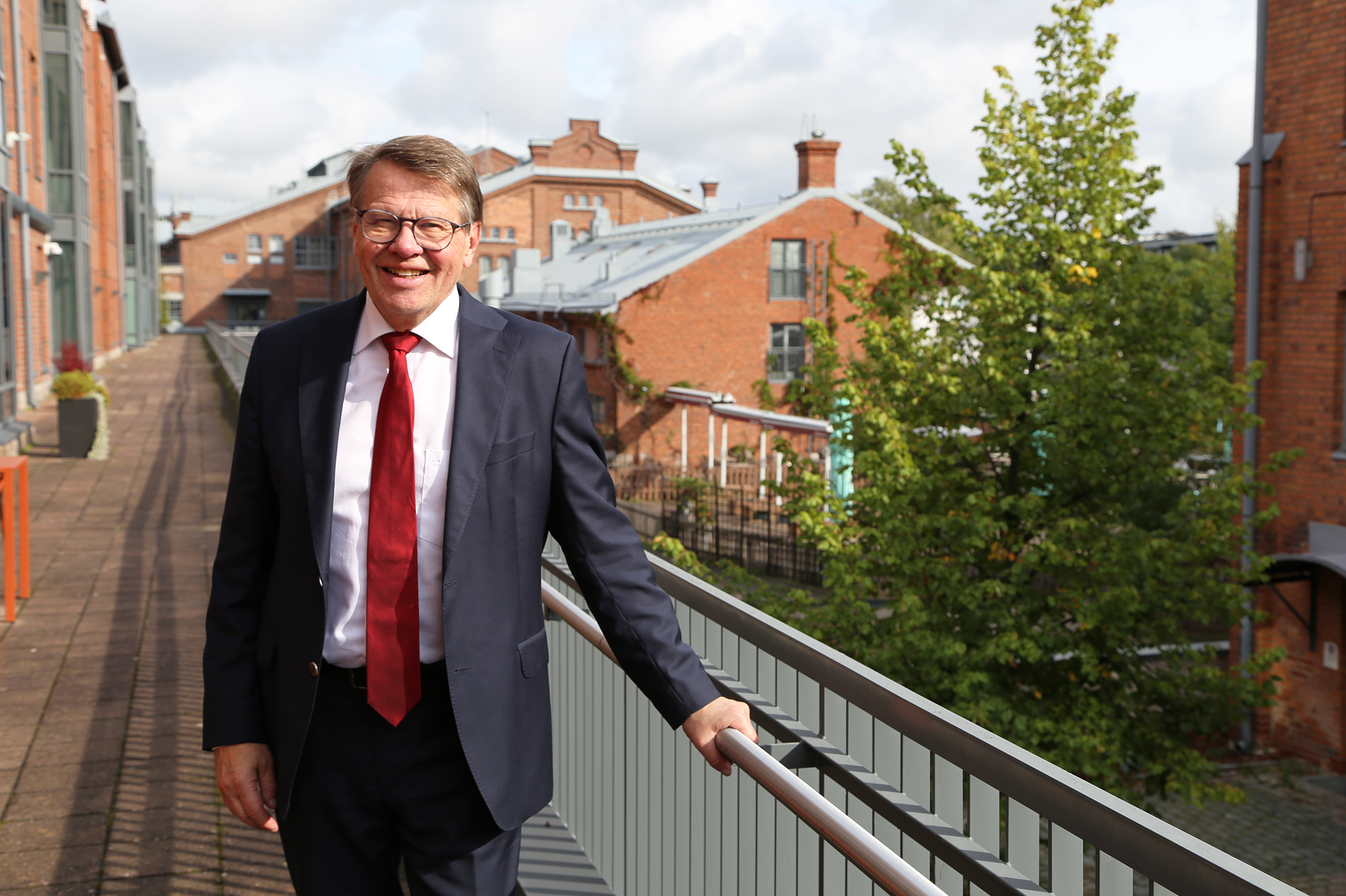 Maakuntajohtaja Kari Häkämies hymyilee aurinkoisella toimiston terassilla